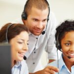 Happy group of call centre employees at work
